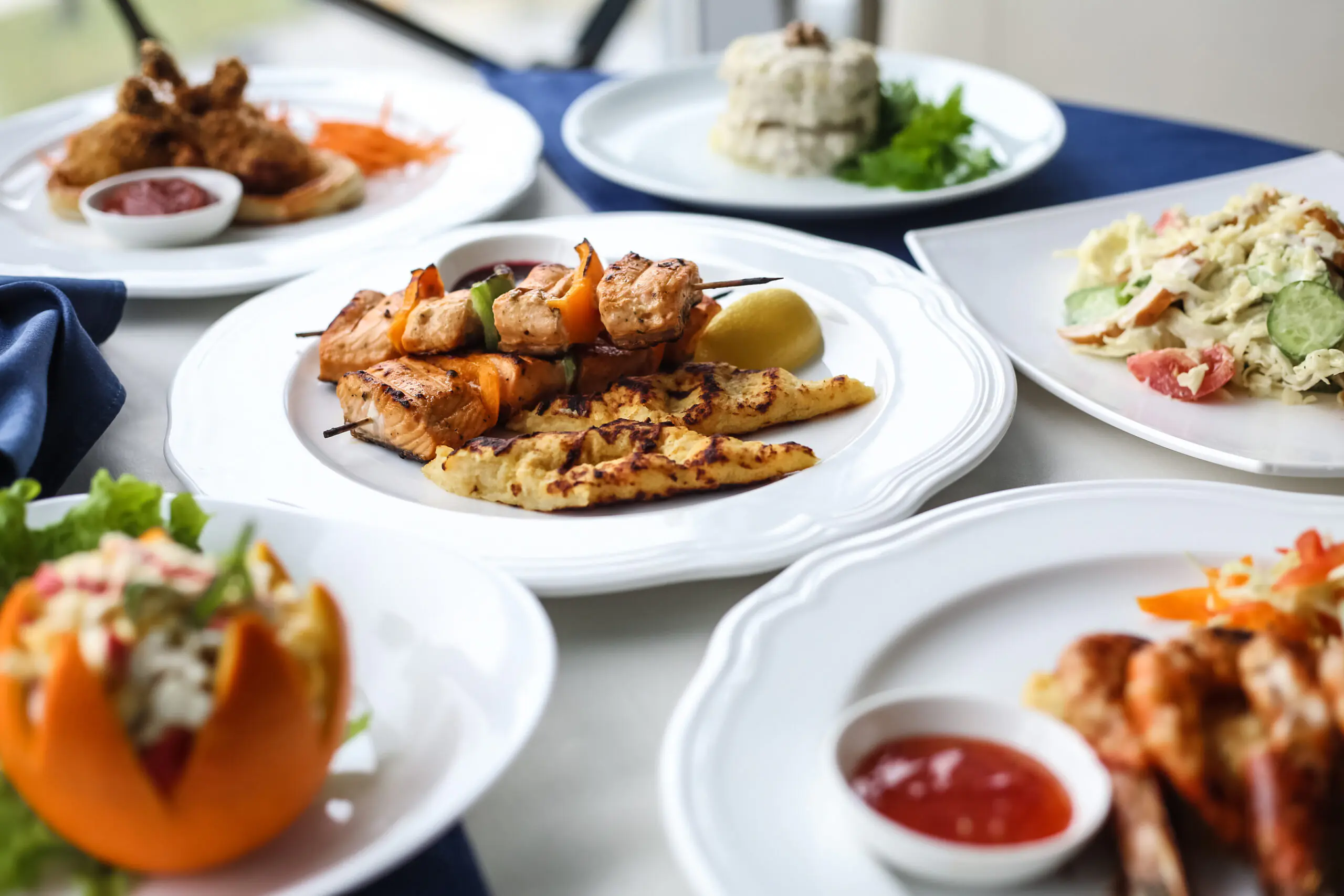 Delicious grilled skewers with fresh salads